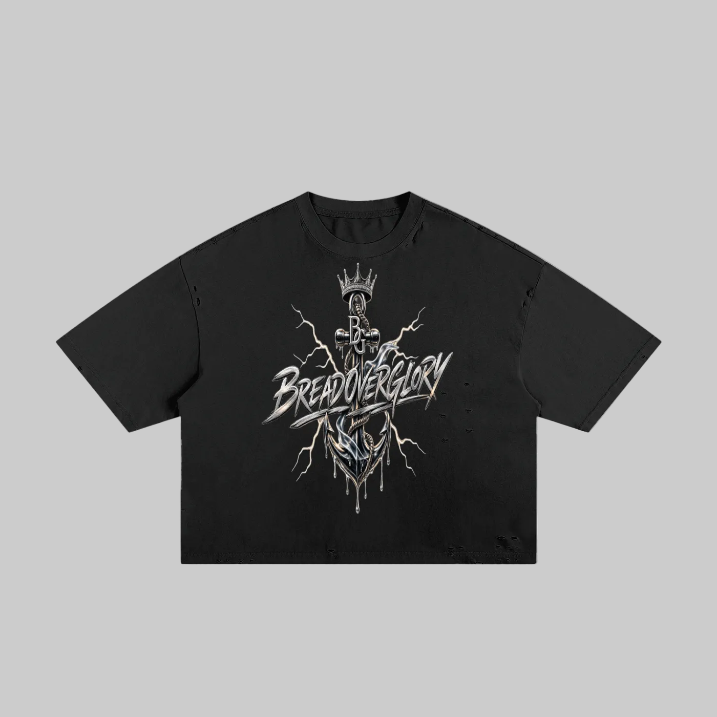 A black short-sleeve crop top t-shirt featuring a detailed graphic print on the front. The graphic depicts a crowned skeleton figure with lightning bolts and the stylized text 'BREAD OVER GLORY' in white and silver.